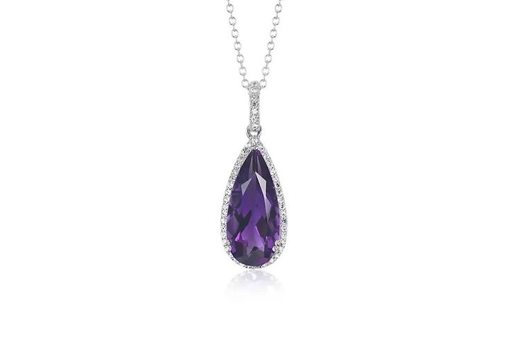 A February birthstone pendant of teardrop-shaped amethyst surrounded in a white topaz halo of twinkling hanging from a coordinating cable chain