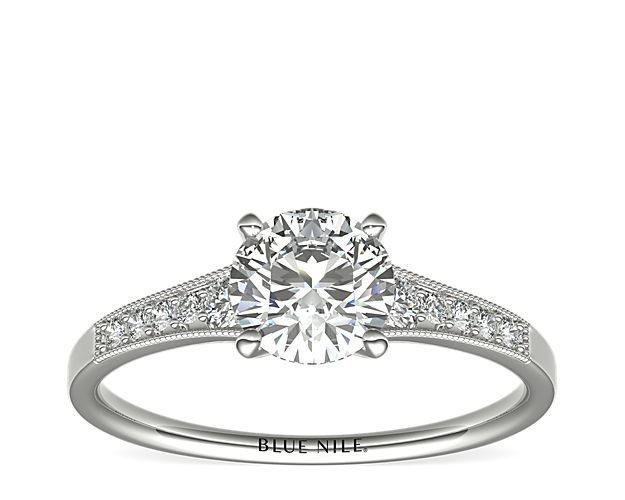 Ideal for any center diamond of your choice, this platinum engagement ring showcases a diamond accent along the shank and milgrain detailing.