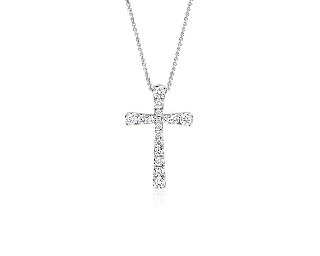 Seventeen brilliant pavé-set round diamonds make up this beautiful cross pendant crafted in 14k white gold.