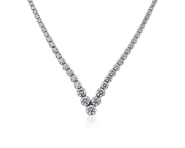 Brilliant round diamonds meet at the elegant point of this necklace, radiating beautiful light that seamlessly transitions from day to night.