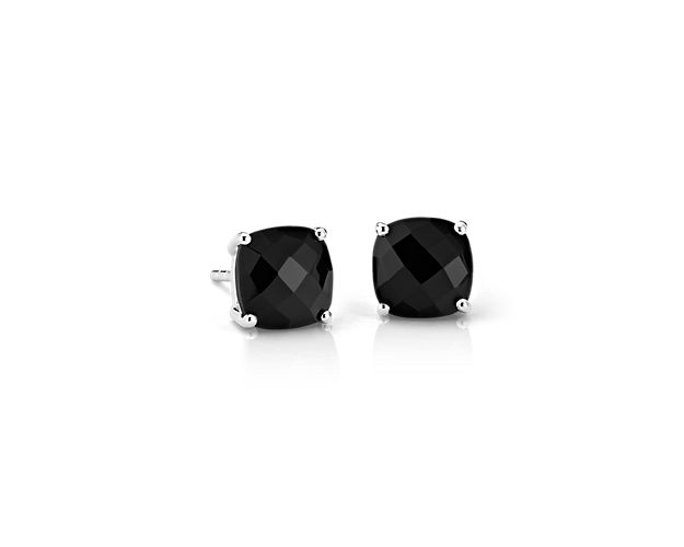 Striking black onyx gemstones, set in polished four-prong sterling silver stud earrings, add a contemporary touch to your everyday style. The unique, faceted cushion shape of the gemstones offers a modern twist on the classic solitaire stud.