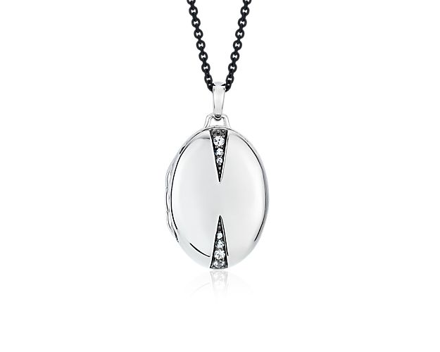 This sterling silver oval locket features triangular accents of white sapphires and hangs from a unique blackened steel chain. Holds two photos of your special someone.