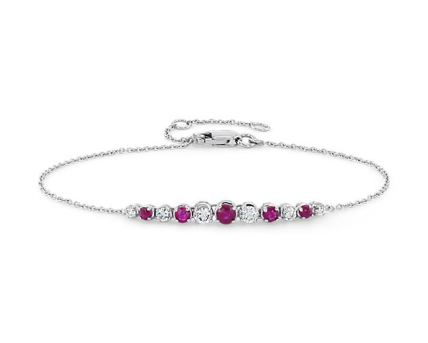 Shine day and night with these brilliant graduated prong-set rubies and diamonds set against 14k white gold, on a delicate cable chain. For added versatility, bracelet can be adjusted in length.