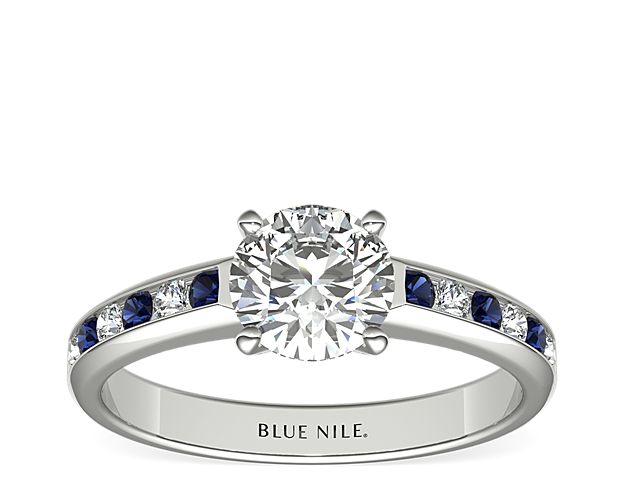 Crafted in 18k white gold, this striking ring setting features alternating deep blue sapphires and round brilliant-cut diamonds set in a channel rather than prongs framing the center diamond of your choice. This style is perfect for a bride who loves color or wants to celebrate the September birthstone, which is the traditional symbol of truth and romance.