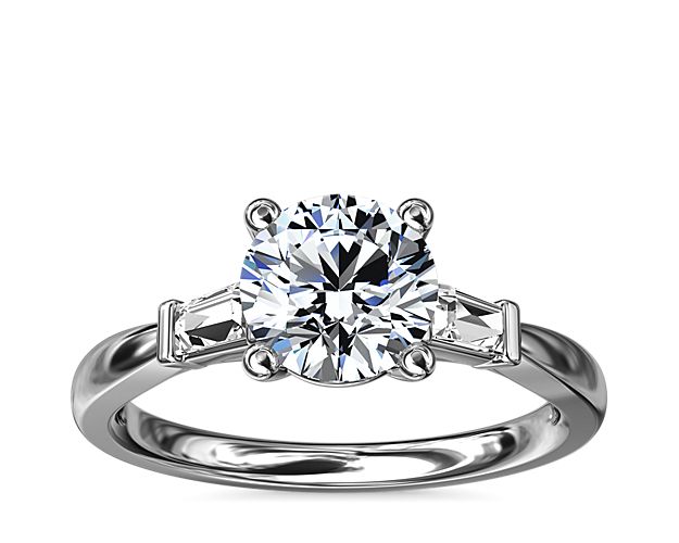 Classic and timeless, this engagement ring features two dazzling tapered baguettes that frame your choice of center stone beautifully.