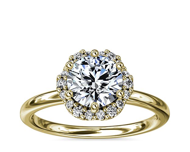 In stunning 14k yellow gold, this six-prong setting supports your choice of center stone while the delicate floral halo surrounds it, accentuating its beauty.