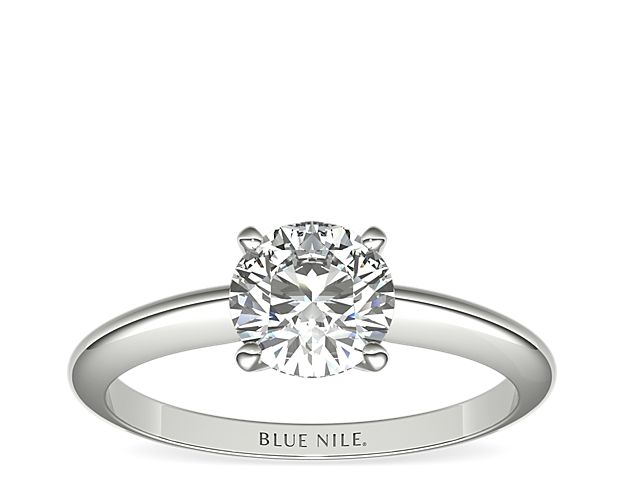 Let your diamond shine brilliantly in this classic 14k white gold four-prong solitaire engagement ring. The slim silhouette and polished finish of this timeless style exemplify timeless style. Select from a variety of diamond shapes to create the perfect classic solitaire engagement ring for you.