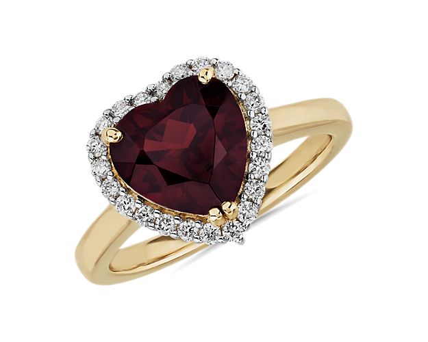 Lend a hint of romance to your look as you slip on this ring featuring a gorgeously hued heart-shaped garnet. A shimmering halo accentuates the stone, and the warm luster of the 14k yellow gold design completes the effect.