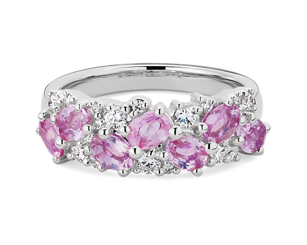 Oval-cut pink sapphires sparkle together with brilliant round-cut diamonds in this breath-taking ring. It is artfully design in lustrous platinum for a look of timeless luxury.