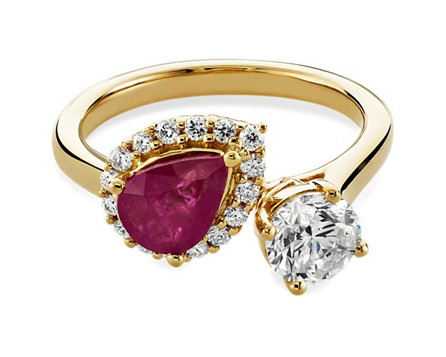 Bring on brilliant sparkle with this gorgeous two stone ring featuring a round-cut diamond and a pear-cut ruby nestled in a stunning diamond halo. The luxurious gleam of the 14k white yellow design perfectly complements the stones.