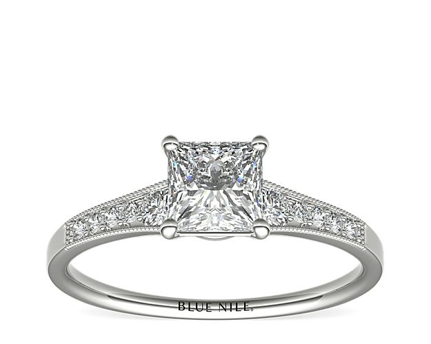 Ideal for any center diamond of your choice, this platinum engagement ring showcases a diamond accent along the shank and milgrain detailing.