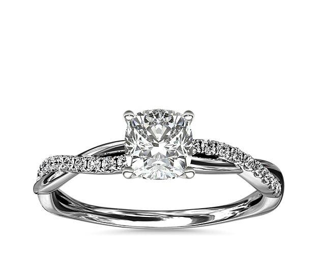 Classic with a twist, this platinum engagement ring features a delicate twist of pavé-set diamonds that will complement the center diamond of your choice.