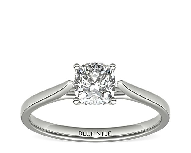 Delicate cathedral shoulders add classic elegance to this petite platinum solitaire engagement ring setting.