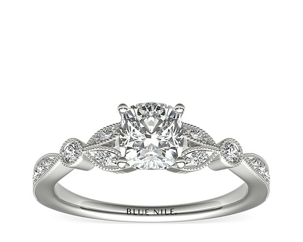 Vintage-inspired, this delicate 14k white gold engagement ring features pavé-set round diamonds surrounded by a milgrain edge.