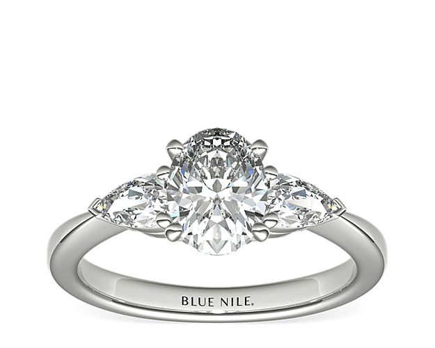 Exceptionally crafted, this diamond engagement ring showcases two beautifully matched pear-shaped diamonds prong-set in platinum to frame your center diamond. Diamonds equal 1/2 carat total weight.