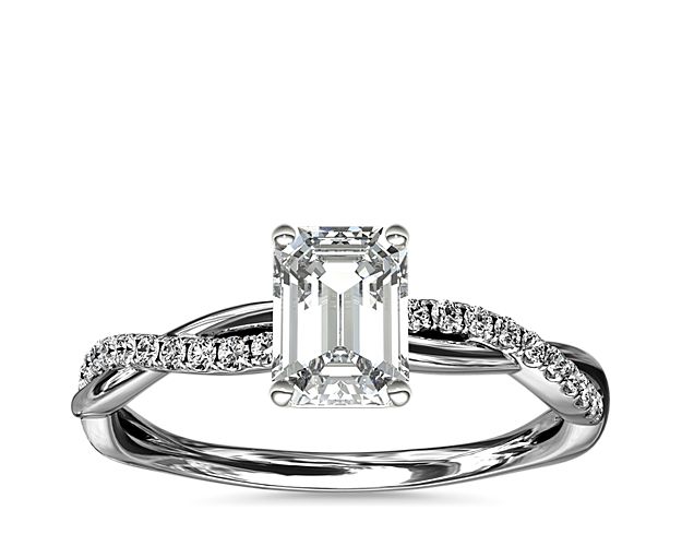 Classic with a twist, this platinum engagement ring features a delicate twist of pavé-set diamonds that will complement the center diamond of your choice.