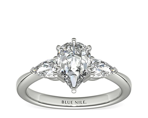 Exceptionally crafted, this diamond engagement ring showcases two beautifully matched pear-shaped diamonds prong-set in platinum to frame your center diamond. Diamonds equal 1/2 carat total weight.