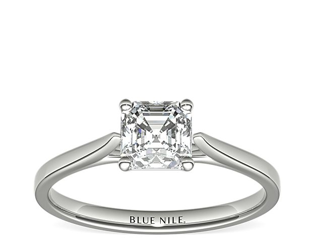 Delicate cathedral shoulders add classic elegance to this petite platinum solitaire engagement ring setting.