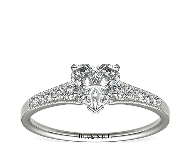 Ideal for any center diamond of your choice, this platinum engagement ring showcases a diamond accent along the shank and milgrain detailing.