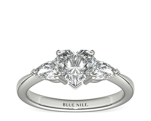 Exceptionally crafted, this diamond engagement ring showcases two beautifully matched pear-shaped diamonds prong-set in platinum to frame your center diamond. Diamonds equal 1/2 carat total weight.