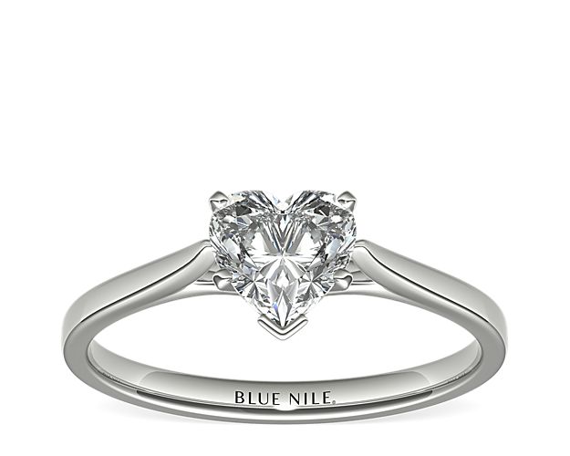 Delicate cathedral shoulders add classic elegance to this petite platinum solitaire engagement ring setting.