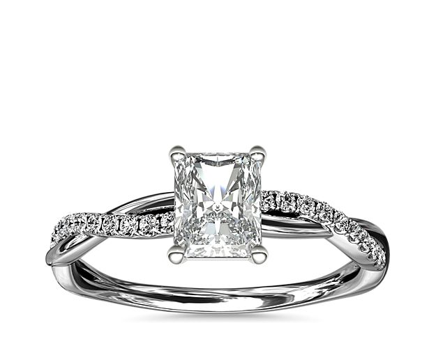 Classic with a twist, this platinum engagement ring features a delicate twist of pavé-set diamonds that will complement the center diamond of your choice.