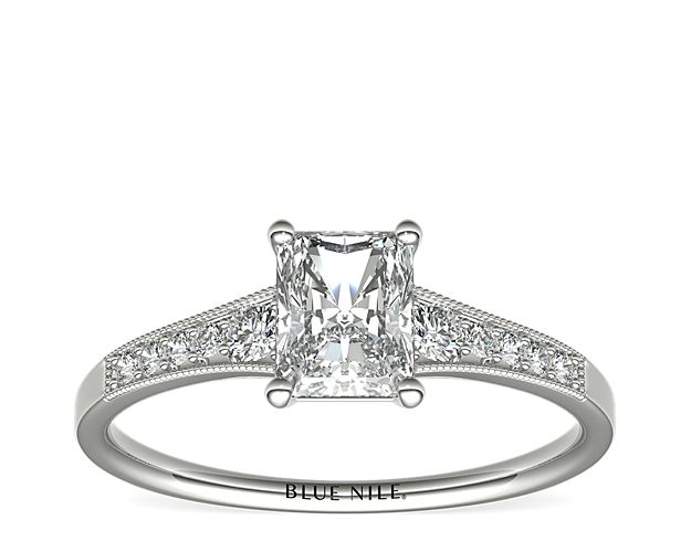 Ideal for any center diamond of your choice, this platinum engagement ring showcases a diamond accent along the shank and milgrain detailing.