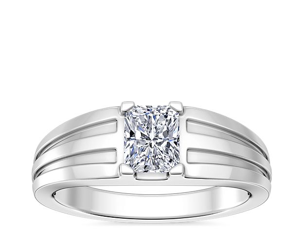 Love shines brilliantly from this engagement ring featuring an elegant center setting that  supports princess (prince), emerald-cut, and radiant-cut diamonds. The lustrous platinum design features beautifully tapered and grooved stylings along the band.