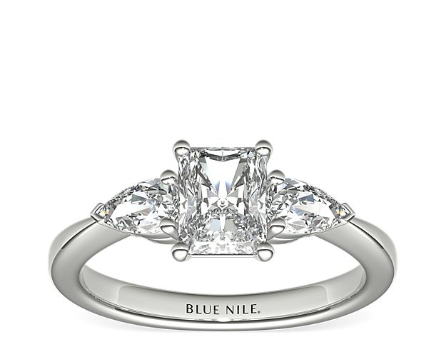 Exceptionally crafted, this diamond engagement ring showcases two beautifully matched pear-shaped diamonds prong-set in platinum to frame your center diamond. Diamonds equal 1/2 carat total weight.