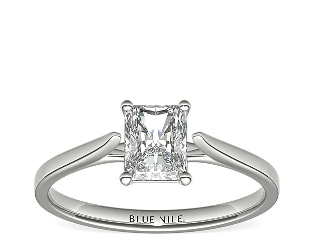 Delicate cathedral shoulders add classic elegance to this petite platinum solitaire engagement ring setting.