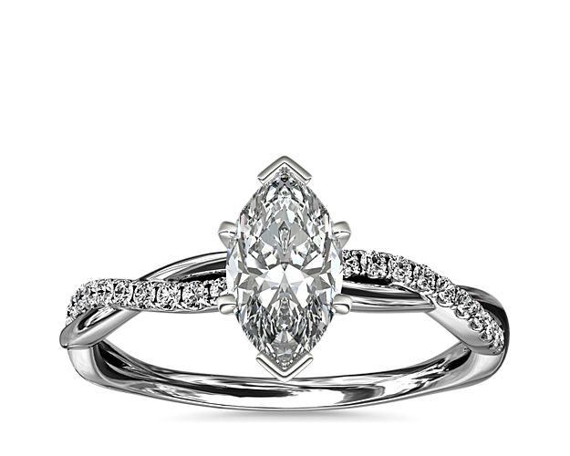 Classic with a twist, this platinum engagement ring features a delicate twist of pavé-set diamonds that will complement the center diamond of your choice.