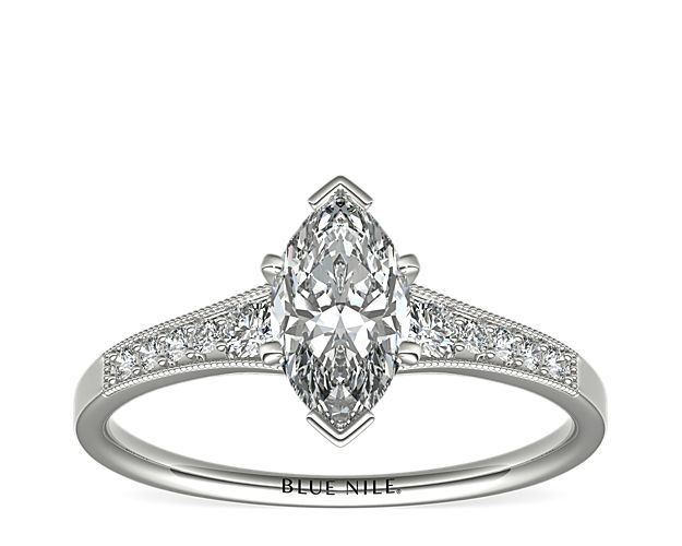 Ideal for any center diamond of your choice, this platinum engagement ring showcases a diamond accent along the shank and milgrain detailing.