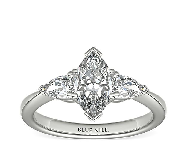 Exceptionally crafted, this diamond engagement ring showcases two beautifully matched pear-shaped diamonds prong-set in platinum to frame your center diamond. Diamonds equal 1/2 carat total weight.