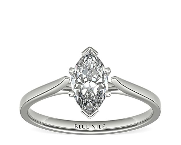 Delicate cathedral shoulders add classic elegance to this petite platinum solitaire engagement ring setting.