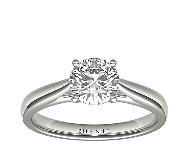 This elegant tapered cathedral solitaire is a timeless engagement ring design. Crafted in enduring platinum, the contoured shoulders perfectly frame your choice of center diamond. This cathedral engagement ring also features subtly rounded inner edges for comfort.