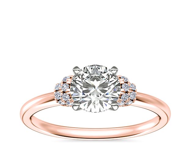 Capture the spirit of your romance with this semi mount engagement ring featuring an elegant center stone setting framed by delicate pavé-set diamonds. The 18k rose gold design lends it a hint of vintage-inspired allure.