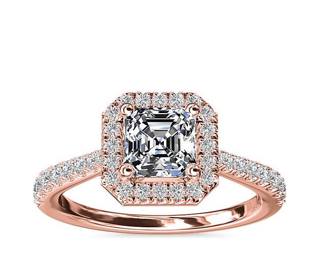 An update to a classic, this dazzling halo engagement ring features a demurely tapered shank and diamond detailing on the profile.  The beauty is in the details - this ring sparkles from every angle and is sure to accent your choice of asscher-cut center stone.