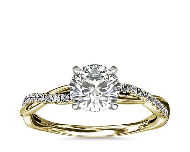 Classic with a twist, this 14k yellow gold engagement ring features a delicate twist of pavé-set diamonds that will complement the center diamond of your choice.