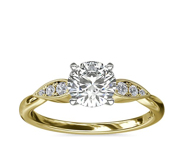 Celebrate love with extra sparkle and the warmth of yellow gold. This beautiful design in 14k yellow gold features delicate pear-shaped details set with three petite diamonds flanking each side of your center stone.