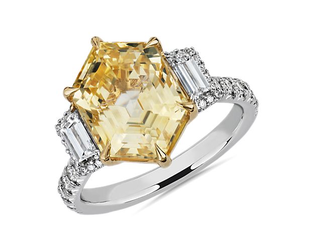 This luxurious one-of-a-kind sapphire ring features a vivid yellow sapphire flanked by two baguette diamonds surrounded by a halo of sparkling diamonds.  Set in 18k white gold, this ring is perfect for your next big occasion.  This ring  is accompanied by gemstone report #:GRS2013-070480.