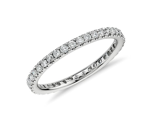 Shimmering round brilliant diamonds encircle this elegant eternity ring designed in 14K white gold and featuring pavé-setting.  A petite diamond ring ideal for a wedding band or stacked with other ring styles.