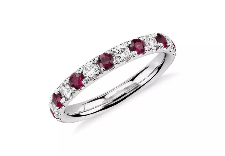 A July birthstone band of alternating ruby and diamond gemstones pavé-set in platinum