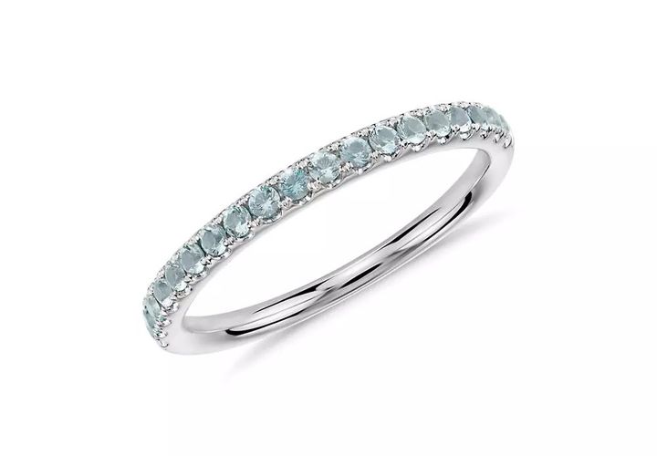 A March birthstone eternity band of round brilliant-cut aquamarines pavé-set in white gold