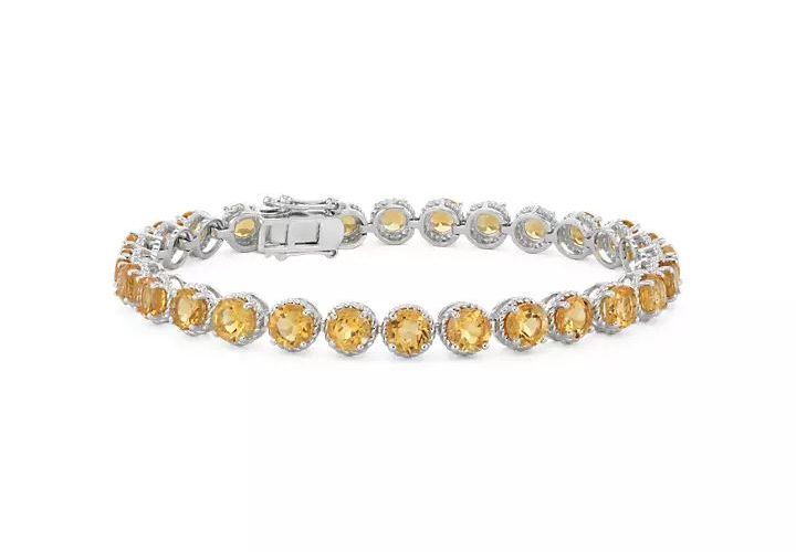 A November birthstone bracelet of twenty-eight round citrine gemstones rimmed in sterling silver miglrain halos