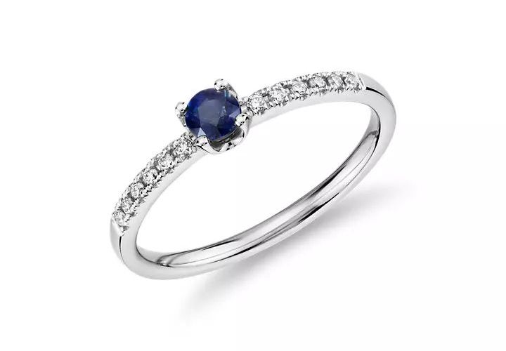 A September birthstone stacking ring showcasing petite sapphire center stone with diamond sidestone accents set in white gold